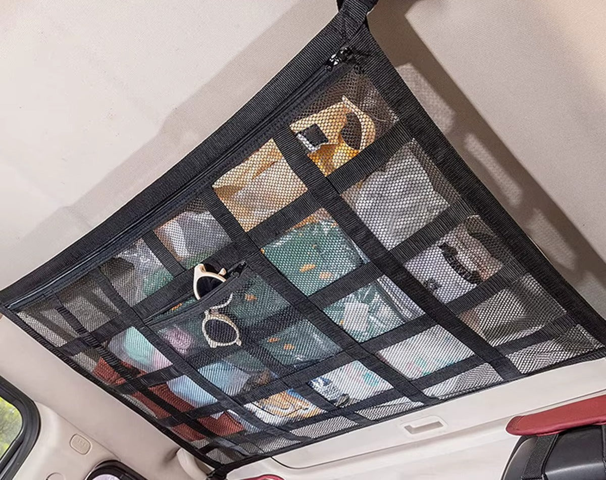 Stashroo ceiling storage net loaded with jackets and towels inside a car